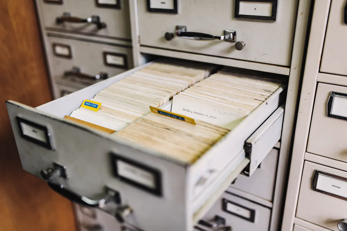 File cabinet with an open drawer containing index cards.